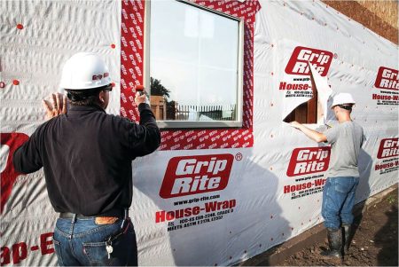 Construction workers using Grip-Rite<sup>®</sup> woven housing wrap